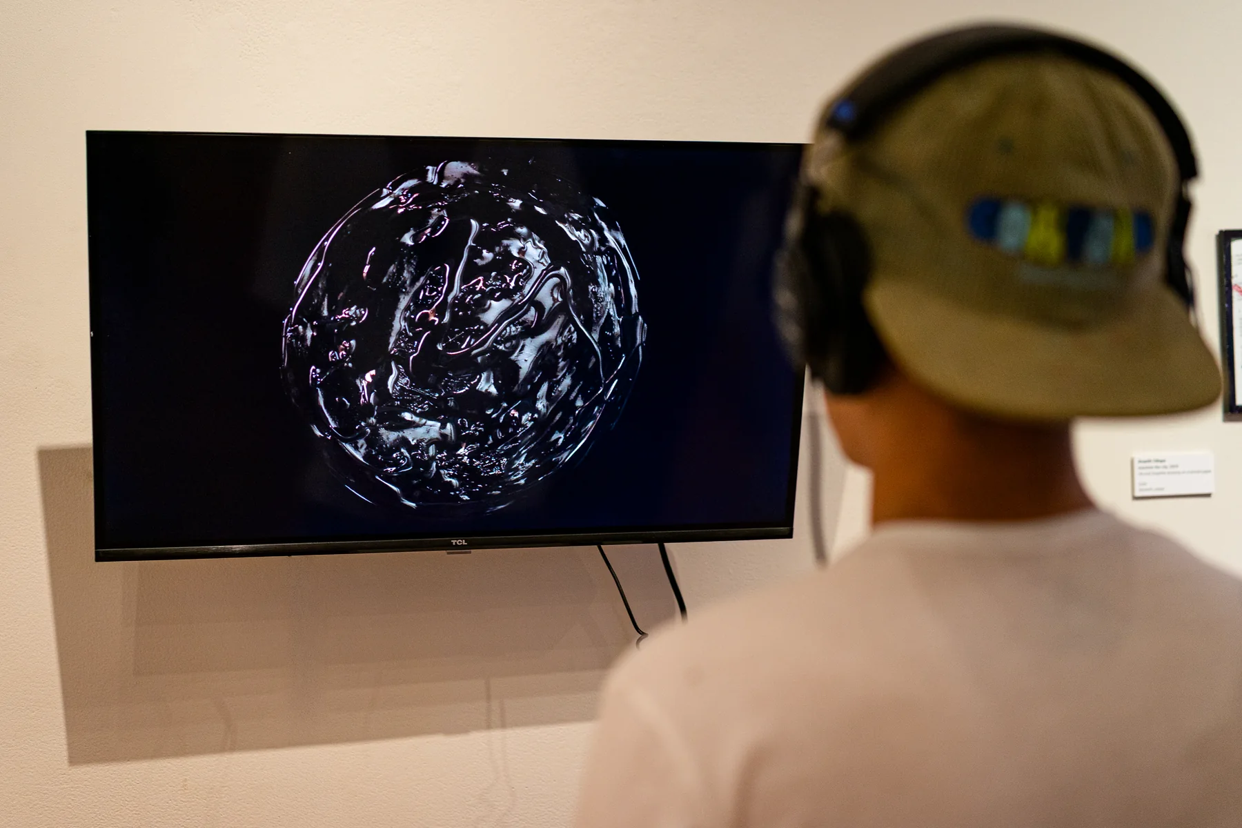 A visitor viewing video art during the All Eyes On You IV opening.