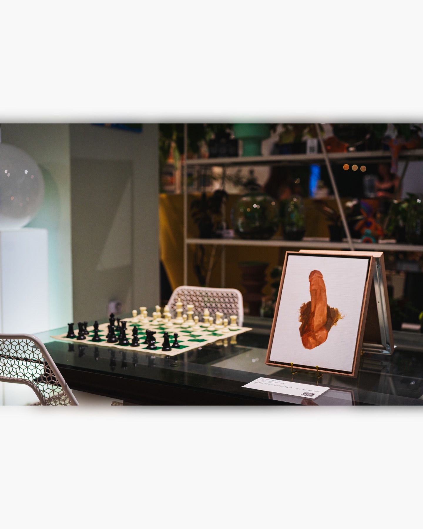 A framed painting and its story card sit beside a chessboard inside Dialog.