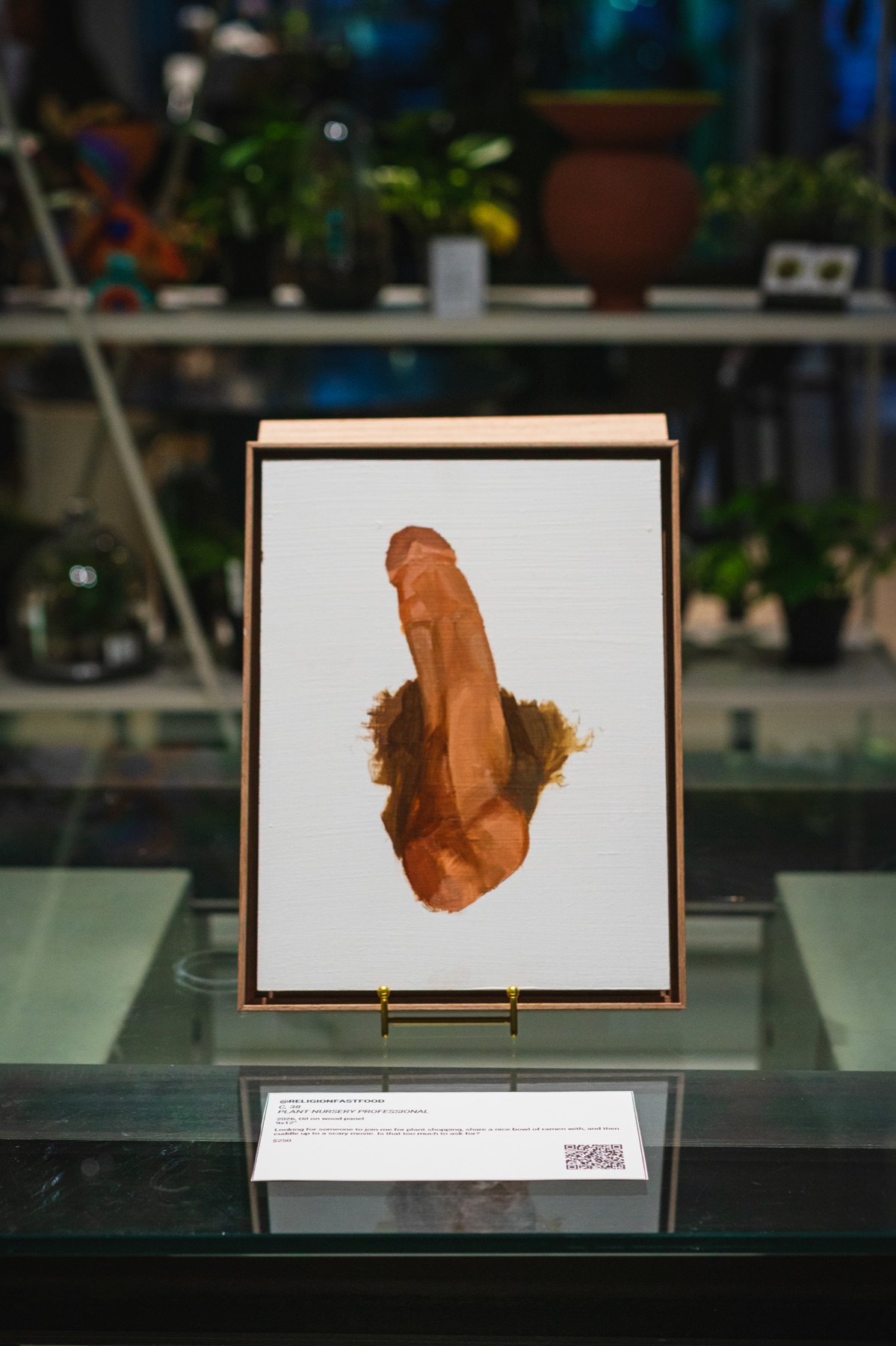 A single framed painting is displayed above its anonymous subject’s story card.