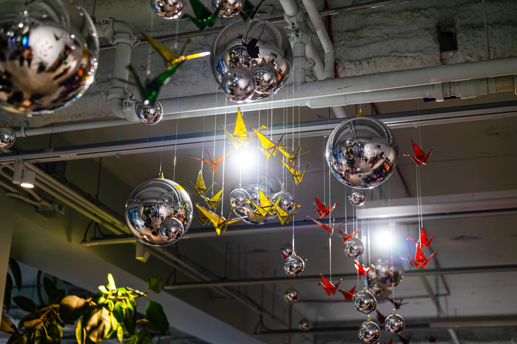 Mirrored spheres and bright folded cranes fill the ceiling above Dialog.