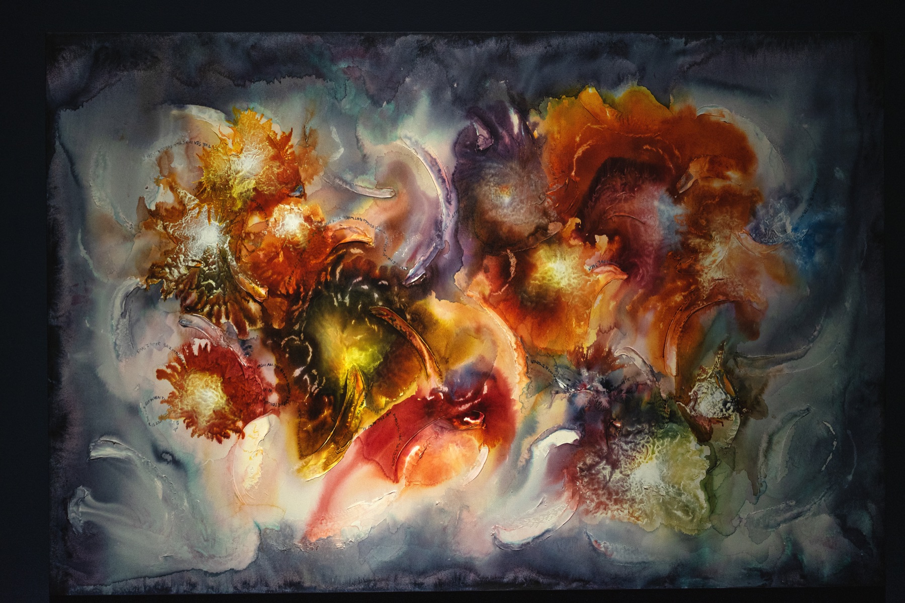 A large luminous abstract painting filled with orange, red, yellow, blue, and violet forms.