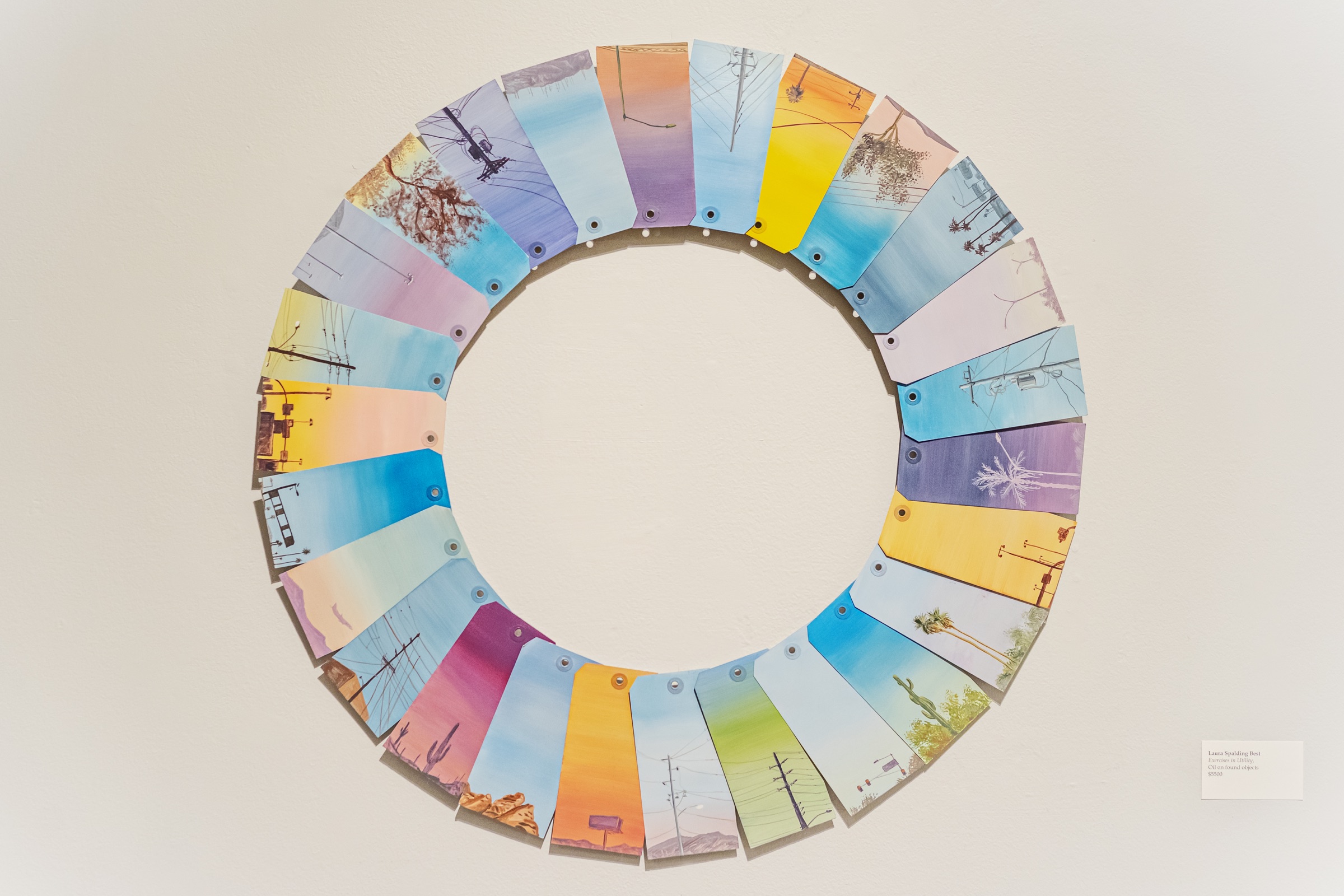 Painted found objects depicting Phoenix infrastructure form a colorful ring.