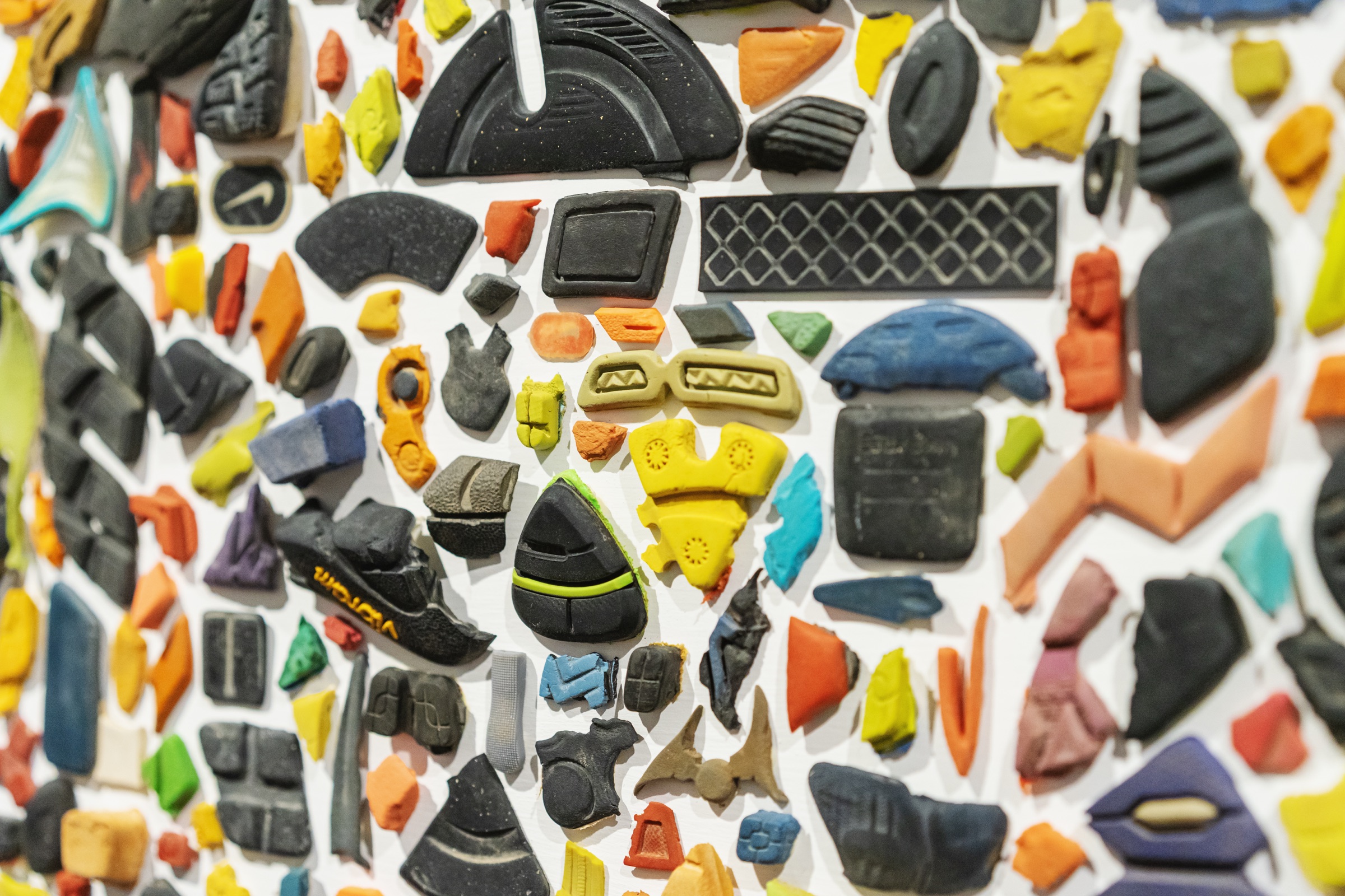 Colorful cast fragments of shoe soles create an abstract field of patterns.