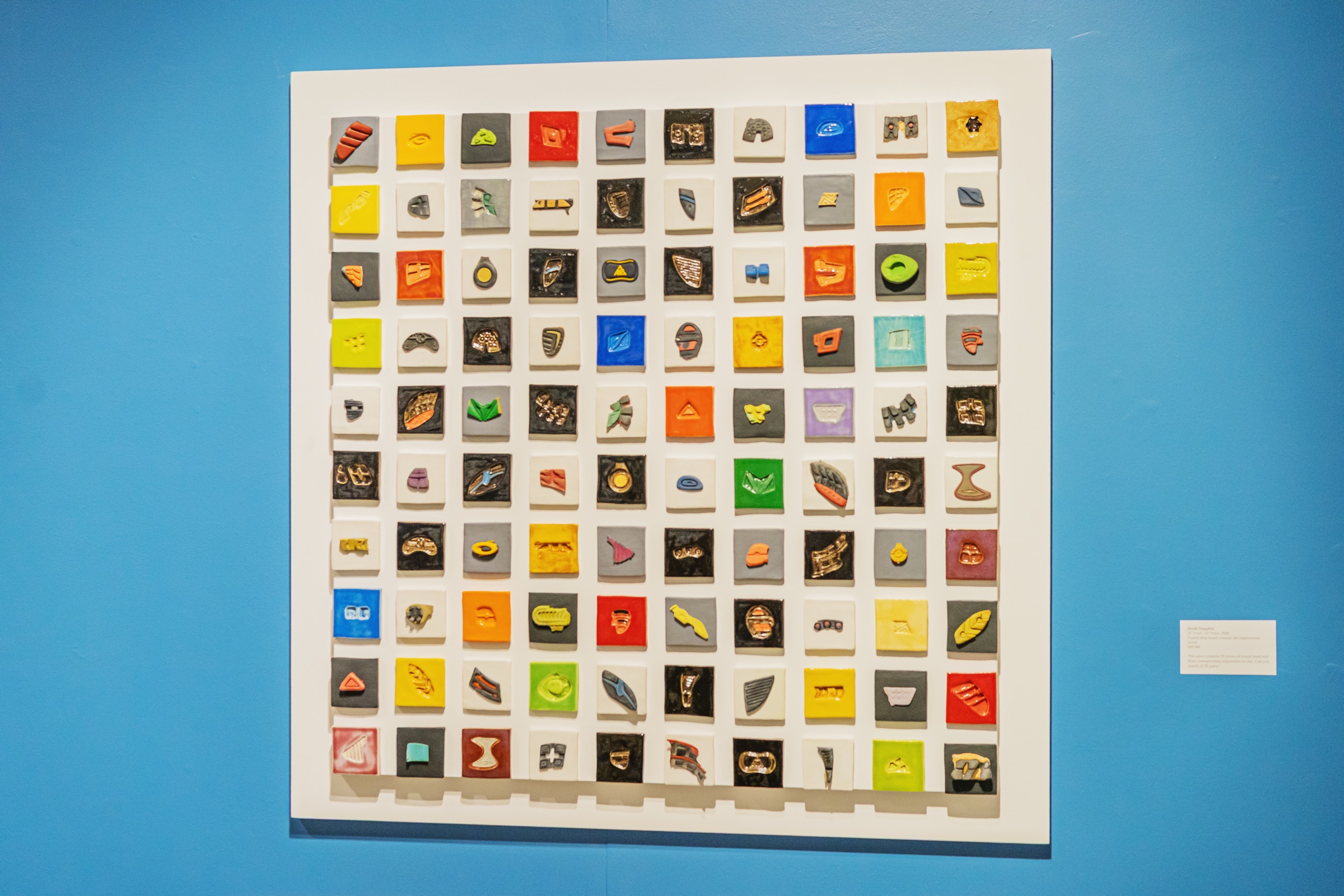 A grid of small colorful tiles preserves individual patterns taken from shoe soles.