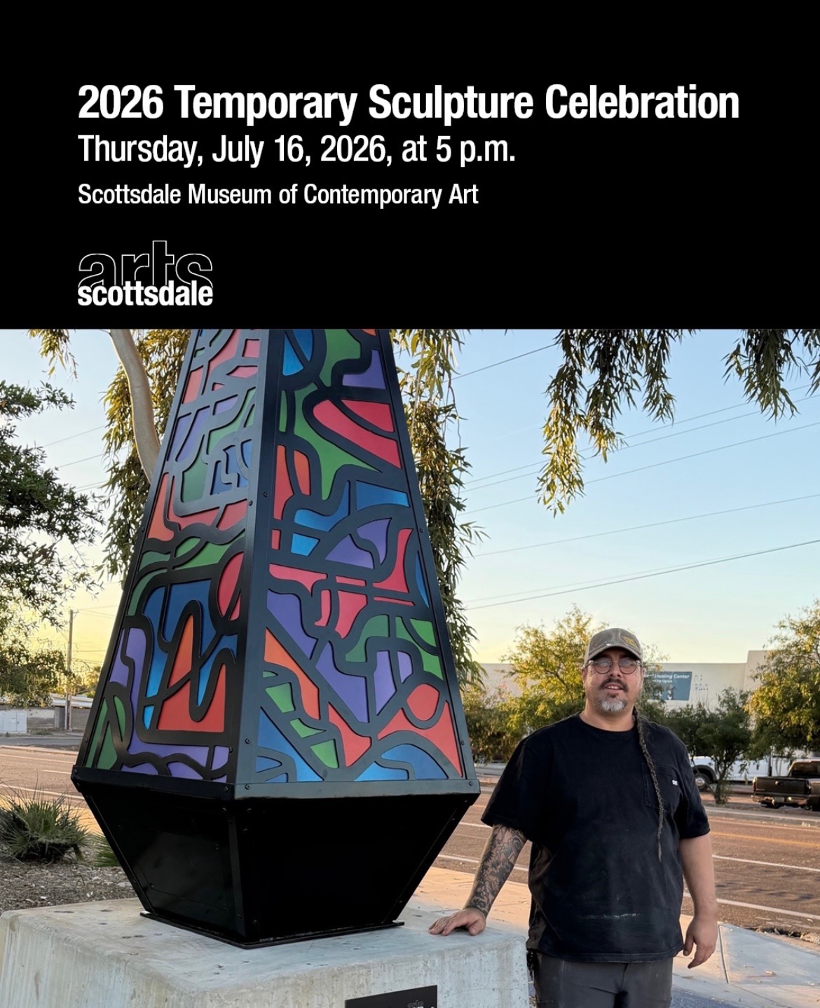 Tyson Krank standing beside his temporary sculpture Proof of Process.
